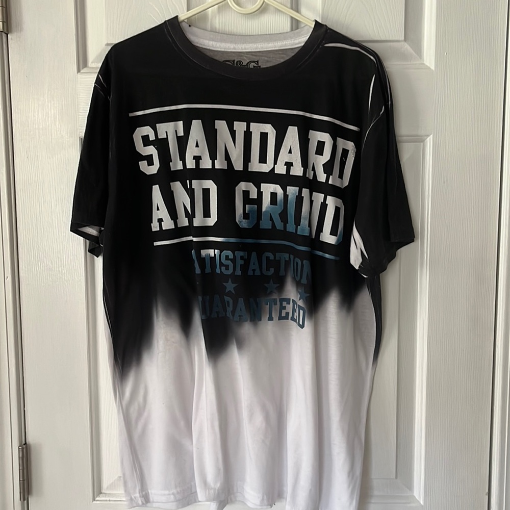 Men’s black and white tee shirt- some wear on letters( see photos)